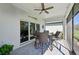 Covered patio with brick flooring, a ceiling fan, and a dining table set at 1848 Sunset Preserve Way, Port Charlotte, FL 33953