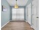 Cozy room with a large window and light blue walls, illuminated by a pendant light at 18908 Nest Fern Cir, Tampa, FL 33647