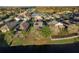 An aerial view showing the community's attractive homes surrounding a scenic lake at 19122 Sunset Bay Dr, Land O Lakes, FL 34638