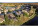 A beautiful aerial view of a home with a screened pool, backing onto a serene lake at 19122 Sunset Bay Dr, Land O Lakes, FL 34638