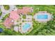 An aerial view of the community clubhouse featuring pools, seating, and palm trees at 19122 Sunset Bay Dr, Land O Lakes, FL 34638