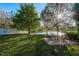 Tranquil backyard featuring a brick patio and a serene lake view for ultimate relaxation at 19122 Sunset Bay Dr, Land O Lakes, FL 34638