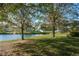Enjoy this serene backyard with lake view and mature trees, creating a peaceful outdoor oasis at 19122 Sunset Bay Dr, Land O Lakes, FL 34638