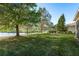 Expansive backyard showcasing a brick patio, screened enclosure and beautiful lake views at 19122 Sunset Bay Dr, Land O Lakes, FL 34638