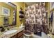 Bathroom featuring vanity with granite countertop, decorative towels, and a floral shower curtain at 19122 Sunset Bay Dr, Land O Lakes, FL 34638