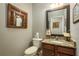 Powder bathroom with a framed mirror, vanity and toilet at 19122 Sunset Bay Dr, Land O Lakes, FL 34638