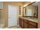 Bathroom vanity featuring dual sinks, granite countertops, and wood cabinets in a neutral color palette at 19122 Sunset Bay Dr, Land O Lakes, FL 34638