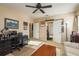 Tan bedroom with a ceiling fan, a couch, and a work desk overlooking the Primary bathroom at 19122 Sunset Bay Dr, Land O Lakes, FL 34638