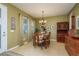 Dining area featuring a chandelier, wooden furniture, and tiled floors at 19122 Sunset Bay Dr, Land O Lakes, FL 34638