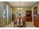 Dining area featuring a chandelier, wooden furniture, and large windows at 19122 Sunset Bay Dr, Land O Lakes, FL 34638