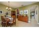 Formal dining area featuring a chandelier, wooden furniture, and tiled floors at 19122 Sunset Bay Dr, Land O Lakes, FL 34638
