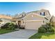 Two-story home with two-car garage, stone accents, and well-manicured lawn at 19122 Sunset Bay Dr, Land O Lakes, FL 34638