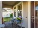 Inviting front porch with seating and a decorative flower arrangement at 19122 Sunset Bay Dr, Land O Lakes, FL 34638