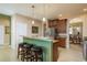 Kitchen with granite countertops, dark wood cabinets, and seating at the bar at 19122 Sunset Bay Dr, Land O Lakes, FL 34638
