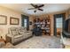 Living room with comfortable seating, bookcase, and natural light at 19122 Sunset Bay Dr, Land O Lakes, FL 34638