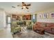 Open-concept living space with cozy seating, a ceiling fan, and seamless flow to the kitchen at 19122 Sunset Bay Dr, Land O Lakes, FL 34638