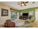 The bright living room includes a ceiling fan, comfortable seating and views of the outdoors at 19122 Sunset Bay Dr, Land O Lakes, FL 34638