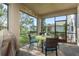 Enclosed patio with wicker furniture and views of the lake, great for outdoor entertaining at 19122 Sunset Bay Dr, Land O Lakes, FL 34638