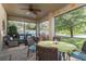 Enclosed patio with wicker seating, ceiling fan, and views of the lake at 19122 Sunset Bay Dr, Land O Lakes, FL 34638