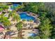 Aerial view of the community pools surrounded by palm trees and lounging areas at 19122 Sunset Bay Dr, Land O Lakes, FL 34638