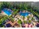 Community pool area with multiple pools, palm trees, and lounge chairs for residents at 19122 Sunset Bay Dr, Land O Lakes, FL 34638