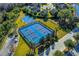 Aerial view of the community tennis and basketball courts with bright blue surfaces at 19122 Sunset Bay Dr, Land O Lakes, FL 34638