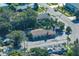 Aerial view of a building with parking, set in a neighborhood with tree coverage and roadways for accessibility at 219 S Betty Ln, Clearwater, FL 33756