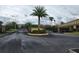 Gated community entrance with mature palm trees and well-maintained landscaping at 2807 Lantern Hill Ave, Brandon, FL 33511