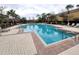Large community swimming pool surrounded by brick pavers and lounge chairs at 2807 Lantern Hill Ave, Brandon, FL 33511