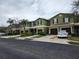 Well-maintained townhomes featuring attached garages and landscaped front yards at 2807 Lantern Hill Ave, Brandon, FL 33511