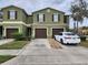 Townhome showcasing its exterior with a well manicured lawn and neutral color scheme at 2807 Lantern Hill Ave, Brandon, FL 33511