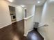 Hallway with wood floors leading to the laundry room and staircase at 2807 Lantern Hill Ave, Brandon, FL 33511