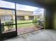 Screened patio showing view of lawn and neighboring buildings at 2807 Lantern Hill Ave, Brandon, FL 33511