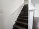 Staircase with wooden steps and white banister leading to the second floor at 2807 Lantern Hill Ave, Brandon, FL 33511