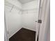 Walk-in closet features shelving and dark hardwood flooring at 2807 Lantern Hill Ave, Brandon, FL 33511