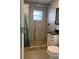 Updated bathroom featuring modern fixtures, stone-look tile, and a stylish vanity at 2912 E North St, Tampa, FL 33610
