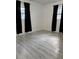 Bright bedroom featuring wood-look floors, and natural light at 2912 E North St, Tampa, FL 33610