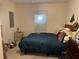 Simple bedroom featuring a bed, a window with blinds, and minimal furnishings at 2980 64Th N Ave, St Petersburg, FL 33702