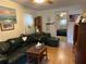 Cozy living room with a large dark couch and a wooden table, leading to a bedroom in the background at 2980 64Th N Ave, St Petersburg, FL 33702
