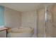Bright bathroom featuring a large soaking tub and a glass-enclosed shower at 3200 Charter Club Dr # A1, Tarpon Springs, FL 34688