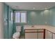 Well-lit bathroom with a toilet, window, and a spacious vanity at 3200 Charter Club Dr # A1, Tarpon Springs, FL 34688