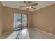 Bedroom with ceiling fan and sliding doors leading to a screened-in patio at 3200 Charter Club Dr # A1, Tarpon Springs, FL 34688