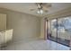 Bedroom featuring tiled floors, ceiling fan, access to a balcony via sliding glass doors at 3200 Charter Club Dr # A1, Tarpon Springs, FL 34688