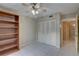 Bedroom featuring tile flooring, ceiling fan and light, large closet with a view to the doorway at 3200 Charter Club Dr # A1, Tarpon Springs, FL 34688