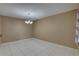 Bright dining room with tile floors, a chandelier, and neutral paint at 3200 Charter Club Dr # A1, Tarpon Springs, FL 34688