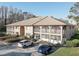 Beige condo building with well-maintained landscaping and visible parking at 3200 Charter Club Dr # A1, Tarpon Springs, FL 34688