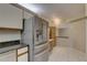 Kitchen with stainless steel refrigerator, light cabinets, stone countertops, and tile floors at 3200 Charter Club Dr # A1, Tarpon Springs, FL 34688