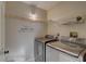 Laundry room featuring side by side washer and dryer with wall decal at 3200 Charter Club Dr # A1, Tarpon Springs, FL 34688