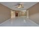 Open-concept living room featuring tile flooring and neutral walls and ceiling fan at 3200 Charter Club Dr # A1, Tarpon Springs, FL 34688