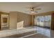 Open living room features tile flooring, ceiling fan and slider leading to outdoor patio at 3200 Charter Club Dr # A1, Tarpon Springs, FL 34688
